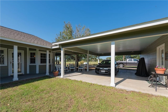 view of car parking with a yard and a carport