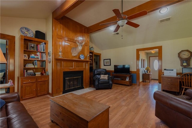 living room featuring light wood-type flooring, lofted ceiling with beams, and ceiling fan