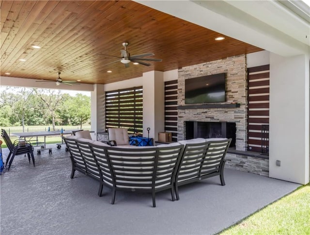 4718 Miramont Cir, Bryan, TX 77802 - view of patio / terrace with an outdoor living space with a fireplace and a ceiling fan