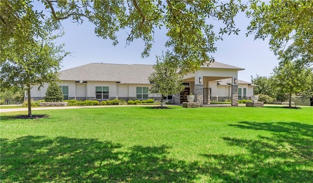 4718 Miramont Cir, Bryan, TX 77802 - view of front of property with stucco siding, a front lawn, and stone siding