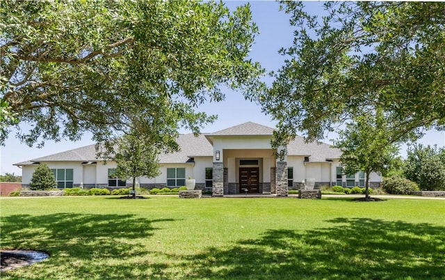4718 Miramont Cir, Bryan, TX 77802 - view of front of home featuring stucco siding, a front yard, stone siding, and french doors