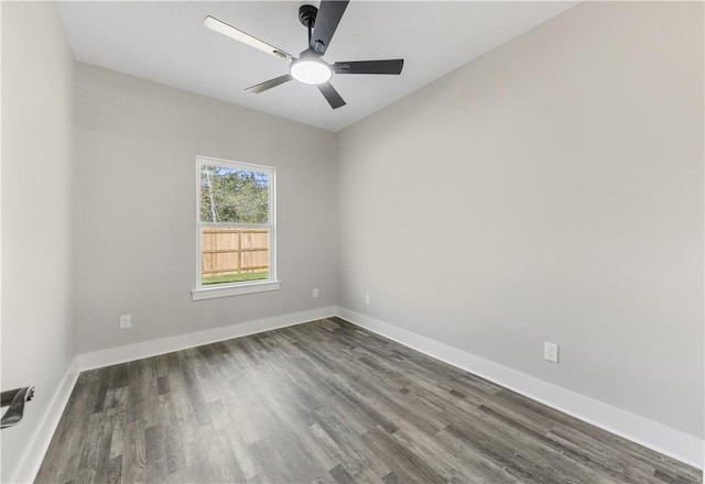 empty room with ceiling fan and dark wood-type flooring