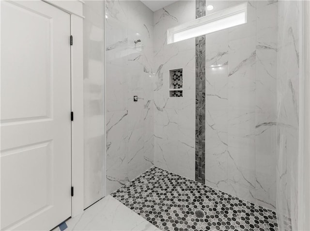 bathroom with tiled shower