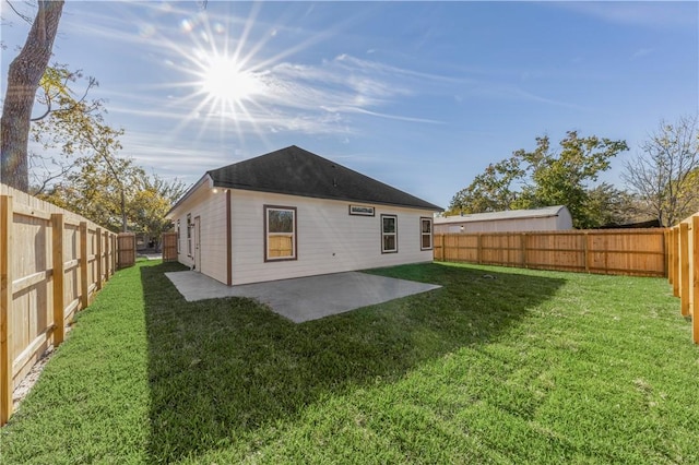 rear view of house with a yard and a patio