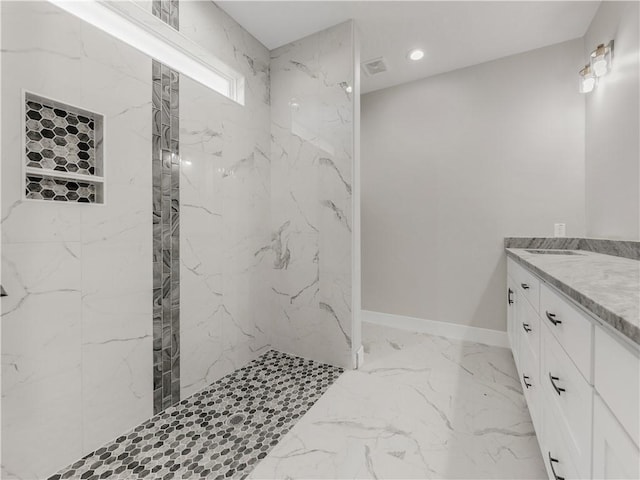 bathroom featuring vanity and a tile shower