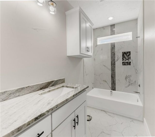 bathroom with vanity and tiled shower / bath