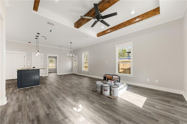 unfurnished living room featuring crown molding, beamed ceiling, dark wood-type flooring, and ceiling fan with notable chandelier