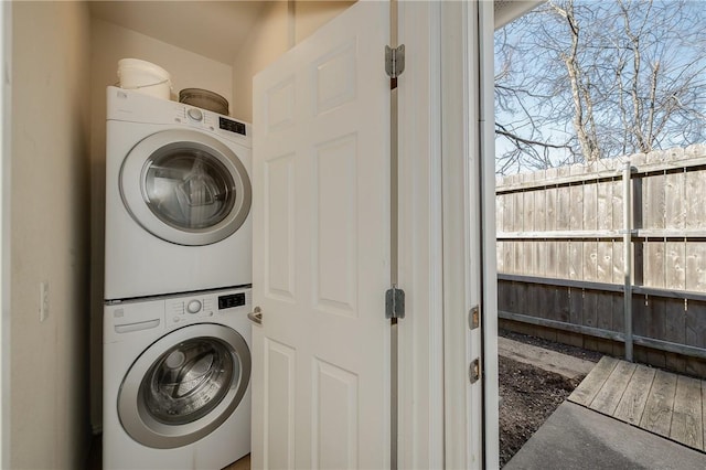 washroom featuring laundry area and stacked washer / drying machine