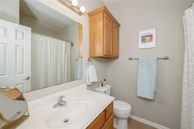 bathroom featuring tile patterned flooring, baseboards, vanity, and toilet