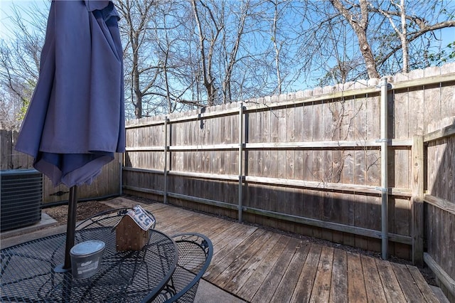 deck featuring cooling unit and fence