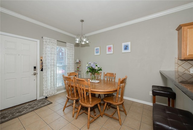 dining room featuring a chandelier, ornamental molding, baseboards, and light tile patterned floors