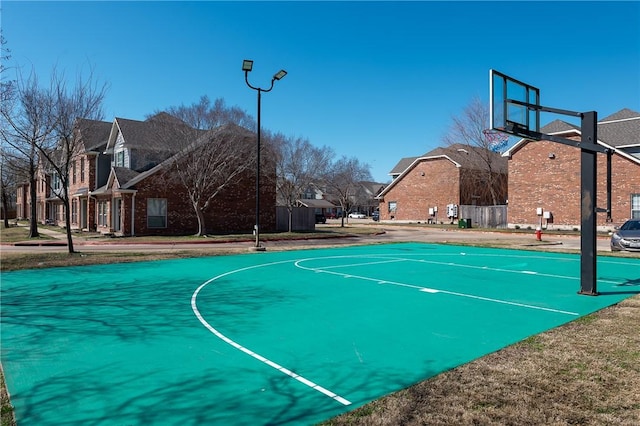 view of basketball court featuring a residential view and community basketball court