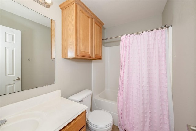 bathroom with vanity, shower / bath combination with curtain, and toilet