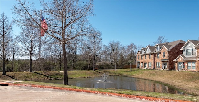 exterior space with curbs and a water view