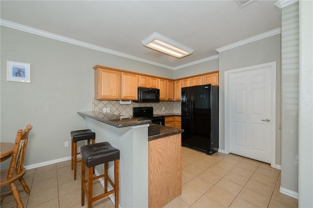 kitchen featuring light tile patterned flooring, a peninsula, ornamental molding, decorative backsplash, and black appliances