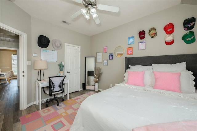 bedroom featuring baseboards, visible vents, ceiling fan, and wood finished floors