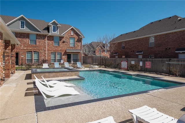 pool with a community hot tub, fence, and a patio