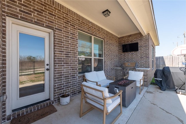 view of patio / terrace featuring an outdoor living space with a fire pit, fence, and area for grilling