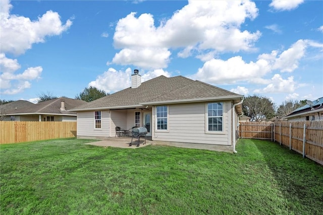 back of house with a lawn and a patio area