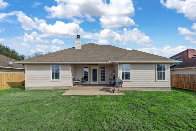 rear view of property with a lawn and a patio area