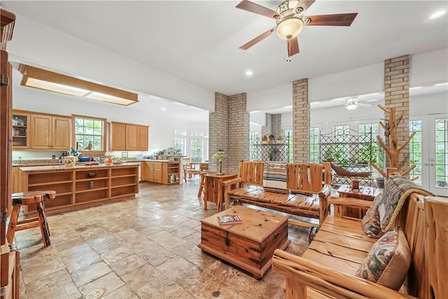 living room featuring ceiling fan and ornate columns