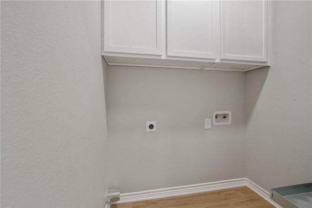 808 N Washington Ave, Bryan, TX 77803 - laundry area featuring hookup for an electric dryer, hookup for a washing machine, cabinet space, wood finished floors, and baseboards