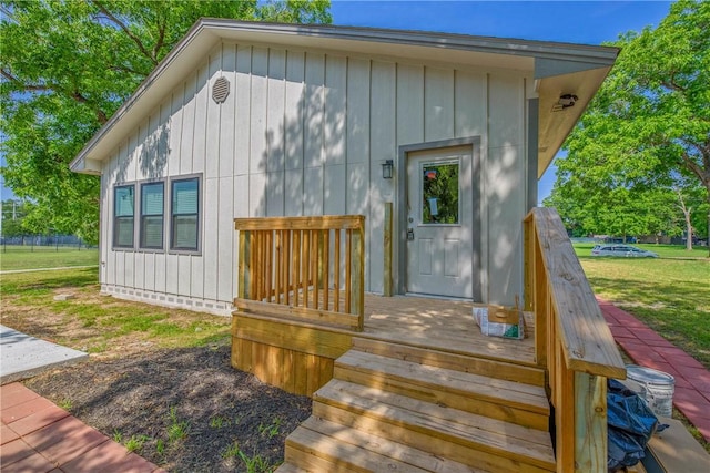 808 N Washington Ave, Bryan, TX 77803 - property entrance featuring a yard, a wooden deck, and board and batten siding