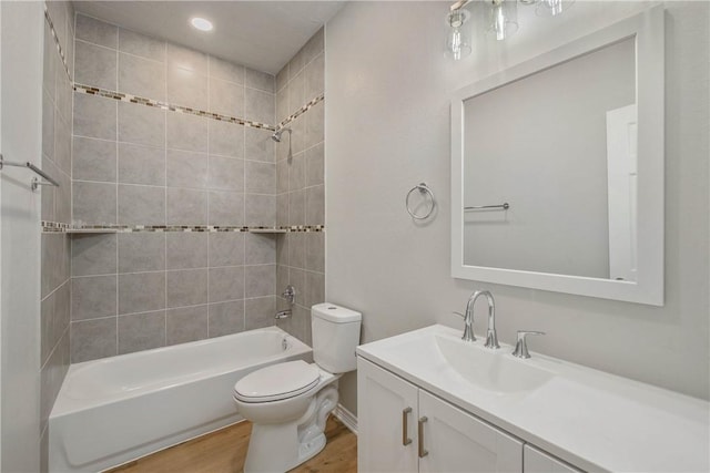808 N Washington Ave, Bryan, TX 77803 - bathroom with toilet, shower / washtub combination, vanity, wood finished floors, and recessed lighting