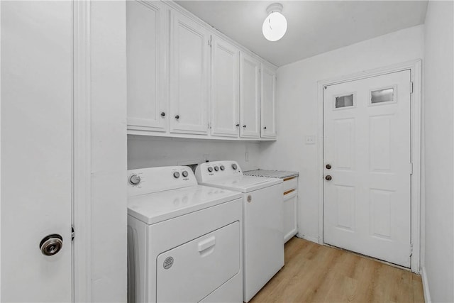 2430 E Briargate Dr, Bryan, TX 77802 - washroom with cabinet space, washer and dryer, and light wood-style floors