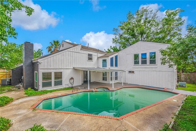 2430 E Briargate Dr, Bryan, TX 77802 - rear view of property with a patio area, cooling unit, a chimney, fence, and an in-ground hot tub