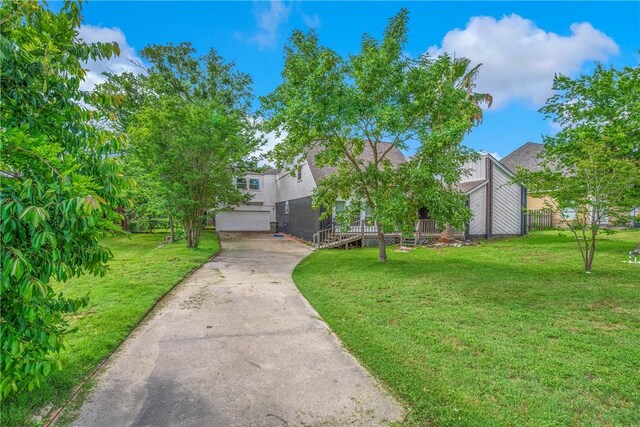 2430 E Briargate Dr, Bryan, TX 77802 - view of property hidden behind natural elements featuring concrete driveway and a garage