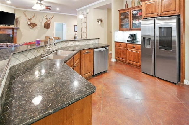 kitchen featuring pendant lighting, stainless steel appliances, crown molding, and sink