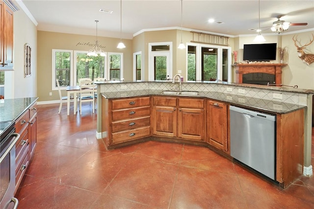 kitchen featuring hanging light fixtures, appliances with stainless steel finishes, a wealth of natural light, and sink