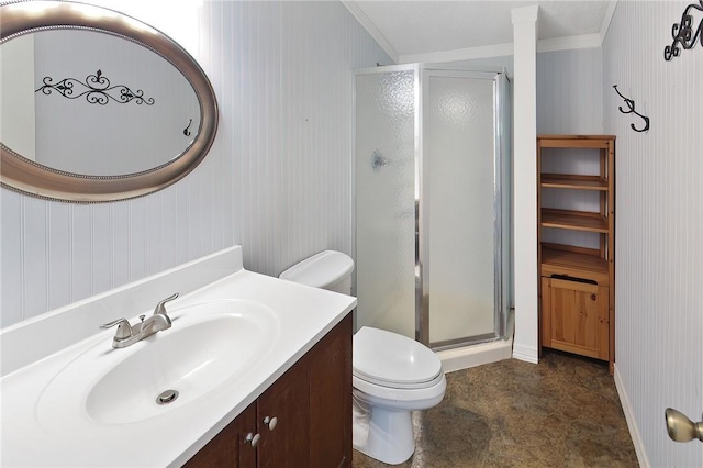 bathroom with crown molding, vanity, a shower with shower door, and toilet