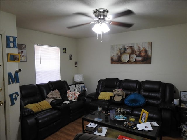 living room featuring dark hardwood / wood-style floors and ceiling fan