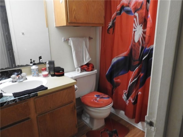 bathroom featuring hardwood / wood-style flooring, vanity, and toilet