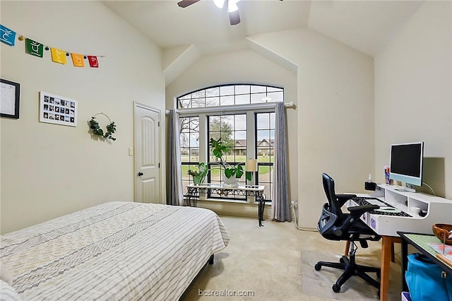 carpeted bedroom with ceiling fan and vaulted ceiling