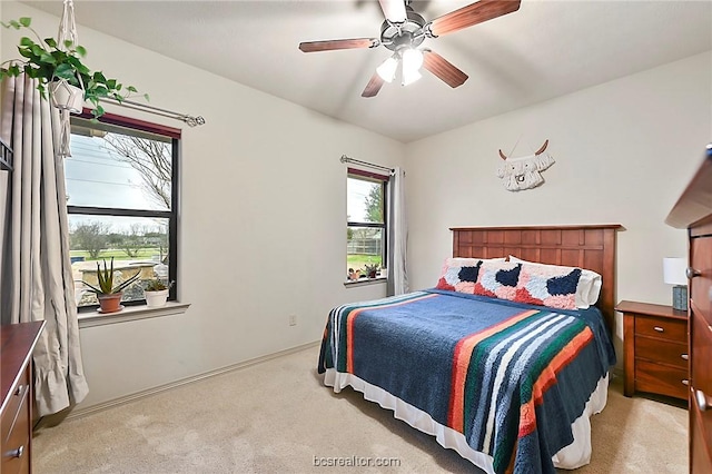 bedroom featuring ceiling fan and light colored carpet