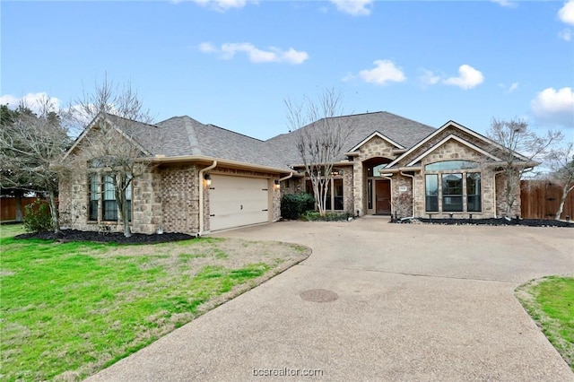 view of front of house with a front yard and a garage