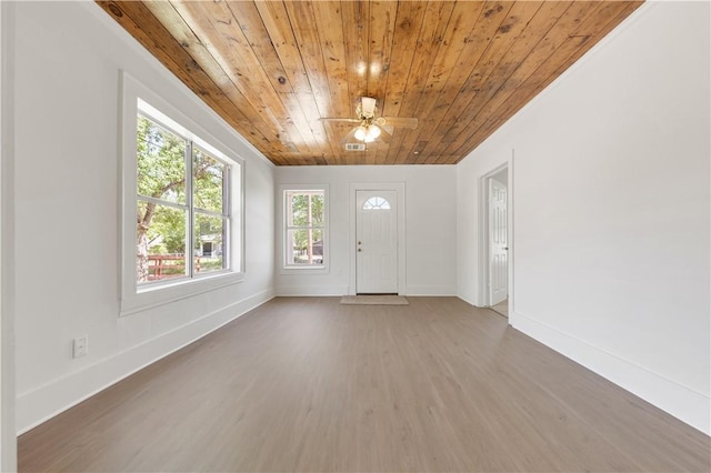 entrance foyer with baseboards, a ceiling fan, wooden ceiling, and wood finished floors