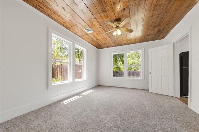 unfurnished room featuring wooden ceiling, ceiling fan, carpet flooring, and visible vents