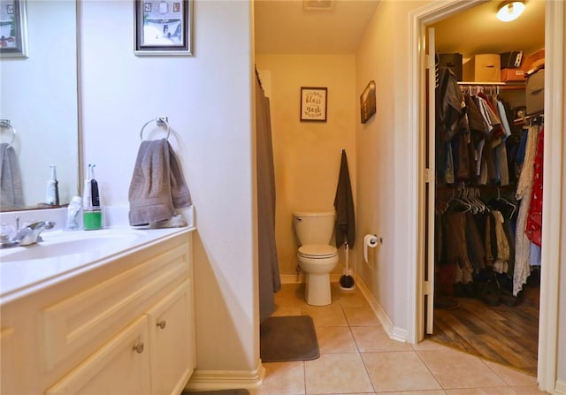 2401 Woodbend Dr, Bryan, TX 77803 - bathroom with vanity, tile patterned floors, and a walk in closet