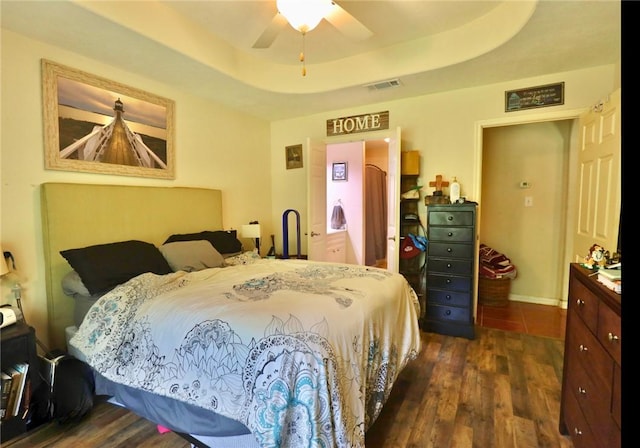 2401 Woodbend Dr, Bryan, TX 77803 - bedroom featuring dark wood-style flooring and a raised ceiling