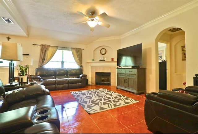 2401 Woodbend Dr, Bryan, TX 77803 - tiled living area with a ceiling fan, arched walkways, crown molding, a fireplace, and a textured ceiling