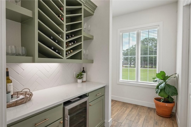 6038 Rain Meadow Dr, College Station, TX 77845 - indoor dry bar featuring wine cooler, baseboards, decorative backsplash, and light wood-type flooring