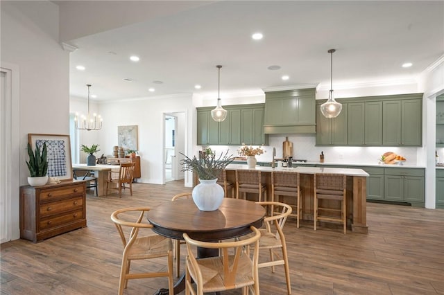 6038 Rain Meadow Dr, College Station, TX 77845 - dining area featuring crown molding, recessed lighting, wood finished floors, and a chandelier