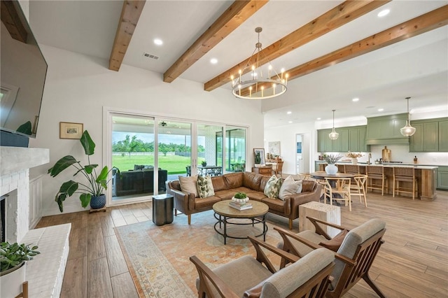 6038 Rain Meadow Dr, College Station, TX 77845 - living room with beamed ceiling, a fireplace, light wood-style floors, recessed lighting, and a chandelier