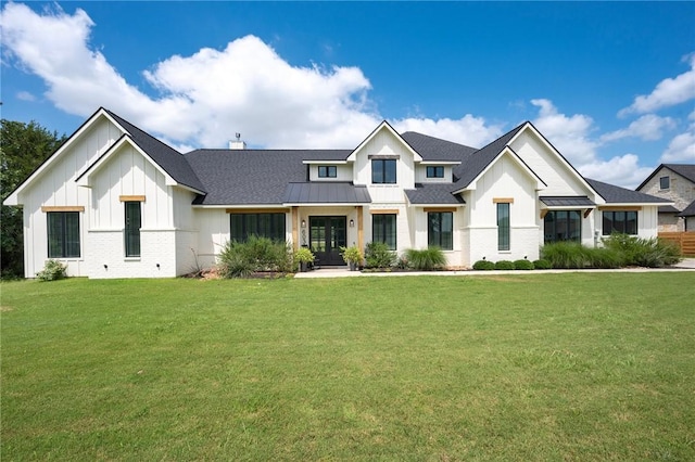 6038 Rain Meadow Dr, College Station, TX 77845 - modern farmhouse style home featuring board and batten siding, a front yard, a standing seam roof, and a shingled roof