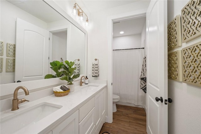 6038 Rain Meadow Dr, College Station, TX 77845 - full bath featuring toilet, double vanity, wood finished floors, recessed lighting, and curtained shower