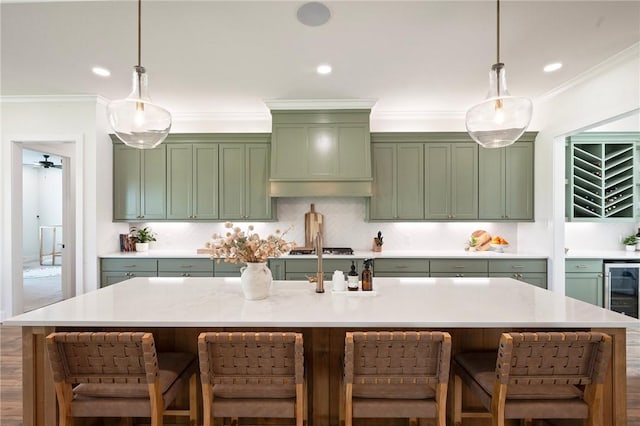 6038 Rain Meadow Dr, College Station, TX 77845 - kitchen featuring green cabinetry, light countertops, decorative light fixtures, crown molding, and recessed lighting